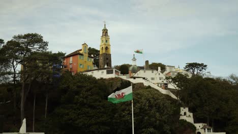 Welsh-Flags-Waving-In-Portmeirion,-An-Italian-Style-Tourist-Village-On-The-Coast-Of-North-Wales,-UK