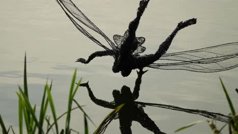 Wire-Fairy-And-Its-Reflection-On-The-Lake-In-Trentham-Estate-Gardens
