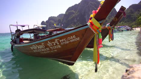 Close-Up-of-Traditional-Thai-Long-Tail-Banana-Boat-Anchored-by-Coast