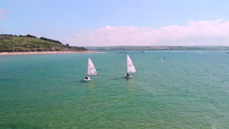 Drone-Flying-Between-Two-Small-Sailing-Boats-in-Cornwall,-England