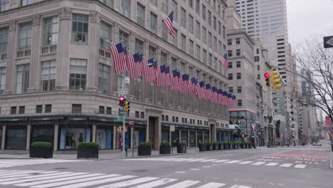 Tilt-up-on-American-Flags-on-deserted-5th-avenue-during-Coronavirus-outbreak