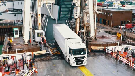 Dolly-out-close-up-shot-of-commercial-cargo-truck-and-lorry-embark-on-the-cross-channel-ferry-freight-heading-to-France