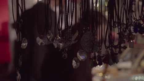 Close-shot-of-necklaces-hanging-in-a-market