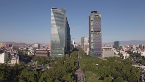 Mexico-City-Downtown-Skyscrapers-and-Green-Park-on-Sunny-Day,-Drone-Aerial-View