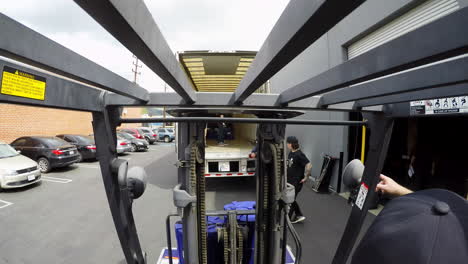 Time-lapse-of-truck-being-loaded-from-forklift-operator-perspective