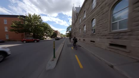 POV-Cycling-Along-Tree-Lined-Rachel-Street-In-Montreal-Before-Stopping-At-Crossing