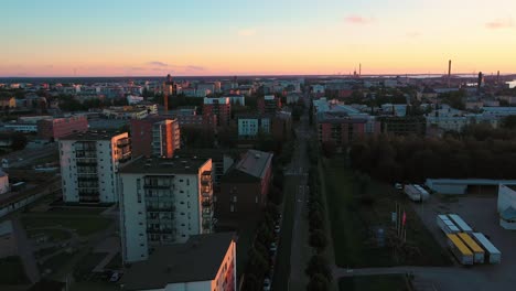 Aerial-view-of-streets-and-apartment-buildings,-sunset-in-Vaasa,--reverse,-drone-shot