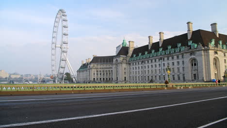 Police-convoy-of-motorbikes-in-London-in-Coronavirus-Covid-19-lockdown-with-quiet-empty-and-deserted-roads-and-streets-at-Westminster-Bridge-and-London-Eye-in-England,-UK