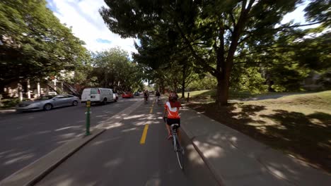 POV-Cycling-Along-Tree-Lined-Rachel-Street-In-Montreal