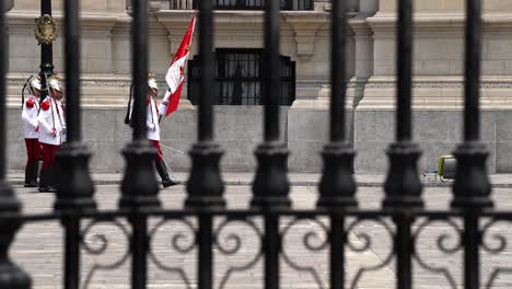 Guards-of-the-Presidential-Palace-In-Peru-Marching,-Seen-Through-Gates