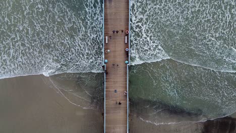 Downwards-Drone-shot-of-pier-in-San-Diego,-California