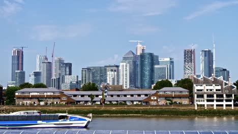 Sunny-day-view-of-Venus-clipper-Uber-boat-by-Thames-Clipper-cruising-by-with-Canary-Wharf-and-Docklands-financial-district-in-the-background
