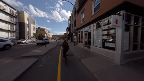 POV-Cycling-Behind-Bike-Messenger-On-Rachel-Street