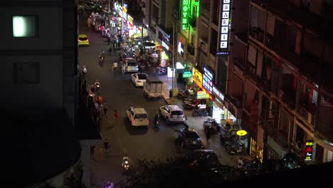 Nightlife-in-Ho-Chi-Minh-Vietnam,-Street-Traffic-and-Illuminated-Shops