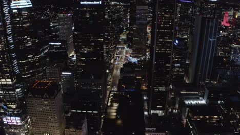 Aerial-View-of-Night-Traffic-Between-Skyscrapers-in-Downtown-Los-Angeles,-California-USA