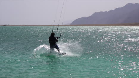 Slow-Motion-of-Kiteboarder-Landing-on-Sea-Water-With-Board-on-Sunny-Summer-Day