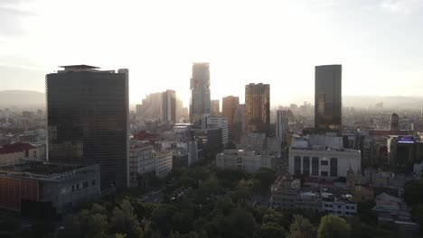 Drone-Aerial-View-of-Mexico-City-Downtown-With-Golden-Hour-Sunlight-in-Backlight