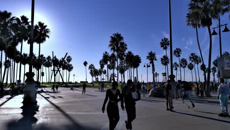 Masked-People-walking-on-the-world-famous-boardwalk-and-beach,-in-Venice,-Los-Angeles,-California,-USA---still-view