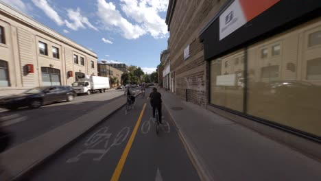 POV-Cycling-In-Between-Traffic-On-Rachel-Street-In-Montreal