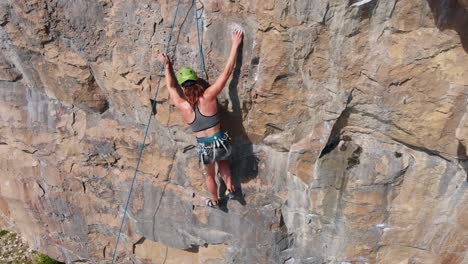 Overhead-Shot-of-Female-Rock-Climber-Successfully-Reaching-Top-Anchor