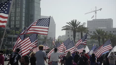 People-holding-American-flags-in-support-of-Veteran's-Day-Parade-2019-in-Downtown-San-Diego