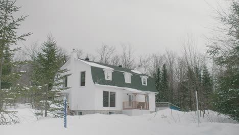 Residential-House-In-Pine-Forest-After-Heavy-Snow-In-Estrie,-Canada