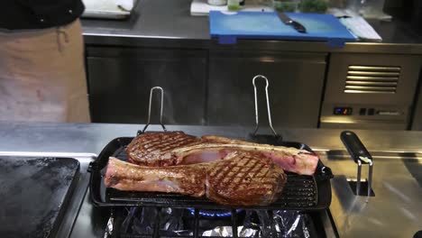 Chef-Turning-Over-Lamb-Chop-On-Grill-In-Kitchen