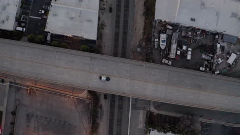 Aerial-drone-shot-of-freeway-overpass-with-passing-police-car