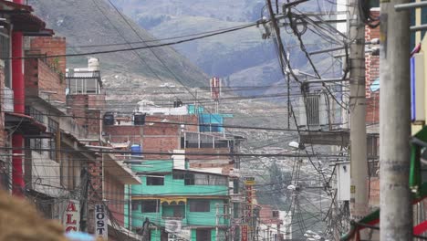 Telephone-And-Power-Lines-From-Poles-In-Street-With-Hillside-View-In-Background-In-Peru