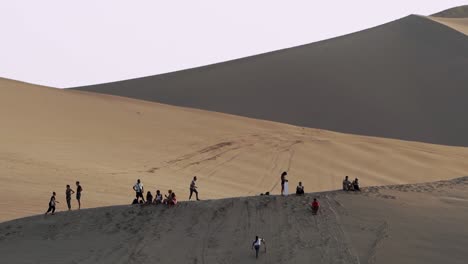People-On-Top-Of-Sand-Dune-Relaxing-In-Peru