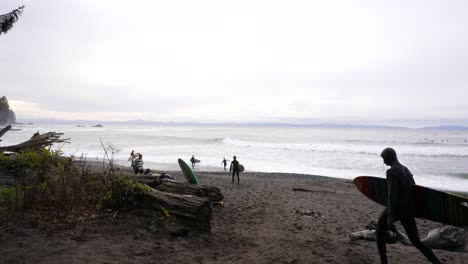Surfers-Carrying-Boards-Walking-on-Sombrio-Beach,-BC-Canada,-Slow-Motion