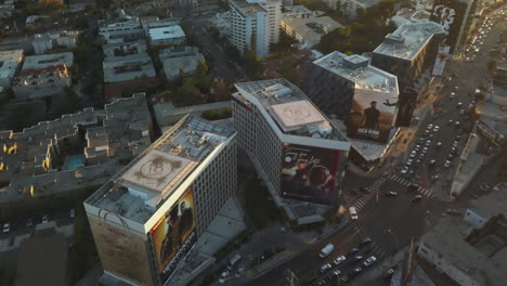 Aerial-View-of-Sunset-Boulevard-Evening-Traffic,-West-Hollywood-Buildings-on-Golden-Hour,-Revealing-Drone-Shot