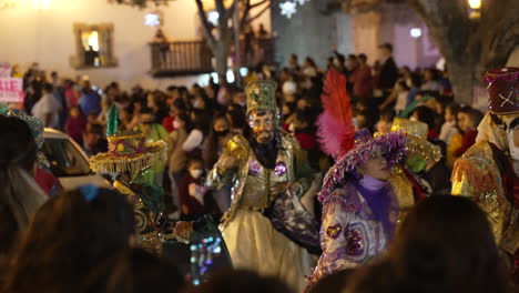 Carnival-in-Taxco,-Mexico,-Night-Streets-Parade-of-Dancers-in-Costumes-and-Crowd-Slow-Motion