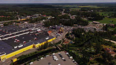 Aerial-view-around-the-horseshoe-monument-at-the-Keskisen-kylakauppa-shopping-mall-in-Tuuri,-Finland---orbit,-drone-shot
