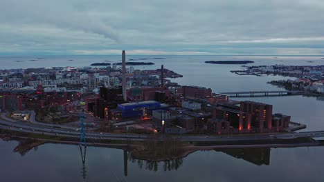Aerial-view-away-from-the-Ruoholahti-industrial-area-of-gloomy-Helsinki---pull-back,-drone-shot