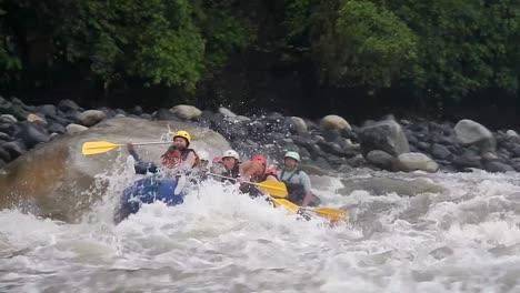A-group-of-men-and-women-are-rafting-in-Baños,-Ecuador,-on-a-river-with-a-strong-current