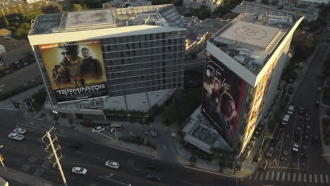 Aerial-View-of-Traffic-on-Sunset-Boulevard,-West-Hollywood,-Los-Angeles-USA,-Buildings-and-Movie-Billboards,-Drone-Shot
