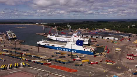 Aerial-view-of-ferries-at-a-shipping-harbor,-sunny,-summer-day-in-Hanko,-Finland---tracking,-drone-shot