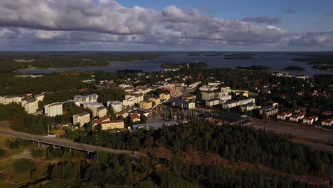Aerial-drone-view-approaching-the-cityscape-of-Naantali,-golden-hour-in-Finland