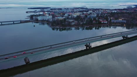Aerial-view-of-following-traffic-on-Lapinlahti-bridge,-road-51-in-Helsinki---static,-drone-shot