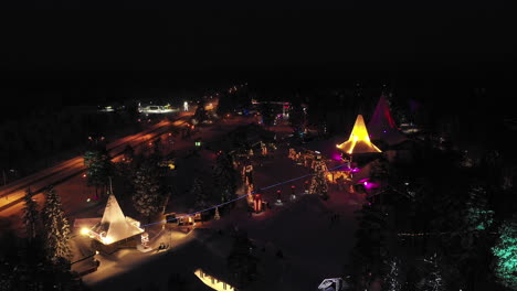 Famous-Santa-Claus-Village-Aerial-at-Nightfall,-Rovaniemi,-Lapland,-Finland,-Established