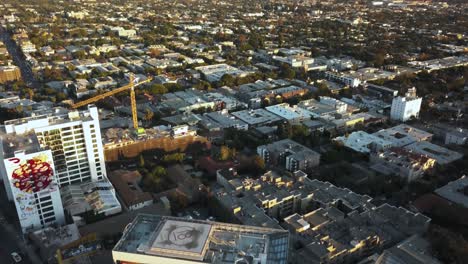 Aerial-View-of-West-Hollywood-and-Downtown-Los-Angeles-in-Skyline-on-Golden-Hour-Sunlight,-Revealing-Drone-Shot
