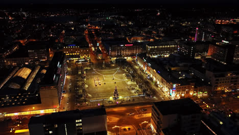 Aerial-view-around-the-illuminated-market-square,-night-in-Vaasa,-Finland