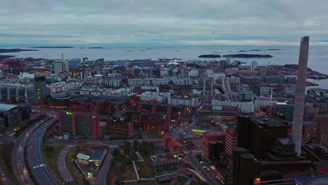 Aerial-view-overlooking-the-Ruoholahti-and-Jatkasaari-cityscape,-in-cloudy-Helsinki---reverse,-drone-shot