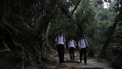 Japanese-highschool-students-walking-down-in-the-Kyoto-shinto-old-forest-park