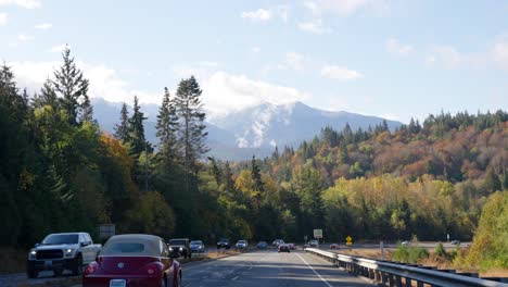 Driving-on-Road-in-British-Columbia,-Canada-on-Sunny-Autumn-Day,-Cars-and-Colorful-Forest,-Slow-Motion