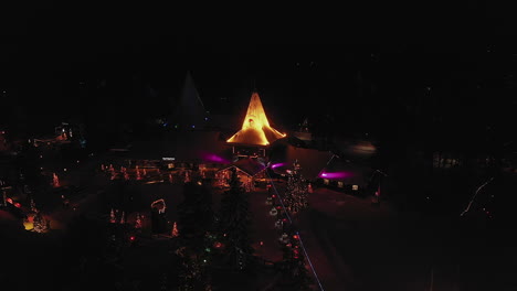 Aerial-View-of-Magical-Colourful-Lights-of-Santa-Claus-Village,-Finland,-Closing-Shot