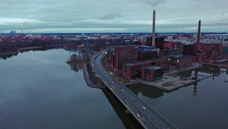 Aerial-view-of-the-Lansivayla-road-in-cloudy-Ruoholahti,-Helsinki---rising,-drone-shot