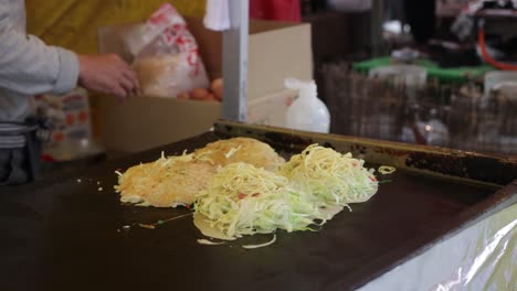 Japanese-chef-cooking-Okonomiyaki-on-the-streets-of-Kyoto-in-Japan