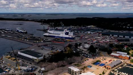 Aerial-hyperlapse-view-of-ferries-and-traffic-at-a-industrial-port,-in-Hanko,-Finland---motion-time-lapse,-drone-shot